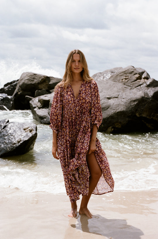 Daughters of India Kyra Midi Dress in Sumac — walking on wet sand at beach, screen print cotton